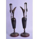 A PAIR OF 19TH CENTURY CONTINENTAL BRONZE CLASSICAL EWERS decorated with figures. 37.5 cm high.