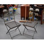 A PAIR OF VINTAGE CAST IRON CHAIRS.