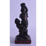 A 19TH CENTURY FRENCH BRONZE FIGURE OF TWO PUTTI modelled tied to a naturalistic post. 20 cm high.