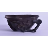 A CHINESE QING DYNASTY CARVED BOXWOOD LIBATION CUP of naturalistic form, with overlaid vines. 9.25