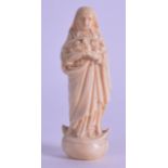 A 19TH CENTURY EUROPEAN CARVED IVORY FIGURE OF MADONNA modelled upon a shaped base. 8 cm high.