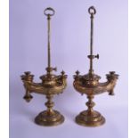 A PAIR OF 19TH CENTURY FRENCH BRONZE ALADDIN LAMPS decorated with mask heads and scrolling acanthus.