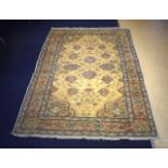 A CAUCASIAN YELLOW GROUND RUG decorated with flowers. 187 cm x 128 cm.