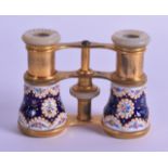 A PAIR OF ANTIQUE ENAMELLED BRASS AND PEARL OPERA GLASSES by Le Maire of Paris, decorated with