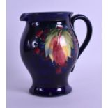 A MOORCROFT BALUSTER JUG decorated with fruiting vines. 15 cm high.