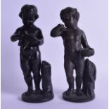 A PAIR OF MID 19TH CENTURY CONTINENTAL BRONZE FIGURES OF CHERUBS modelled upon circular bases. 22 cm