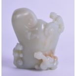 A GOOD CHINESE CARVED GREEN JADE BRUSH WASHER of naturalistic form, overlaid with clambering