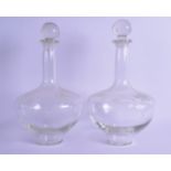 A PAIR OF EARLY 20TH CENTURY ENGRAVED BULBOUS GLASS DECANTERS AND STOPPERS decorated with flowers.