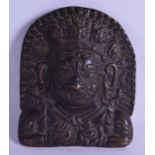 A 19TH CENTURY TIBETAN BRONZE PORTRAIT PANEL depicting a buddhistic figure holding a ritual