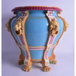 A LARGE 19TH CENTURY MINTON MAJOLICA CIRCUALAR JARDINIERE with lion ring mask head handles, upon paw