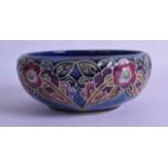 A ROYAL DOULTON STONEWARE BOWL decorated with stylised flowers. 17 cm diameter.