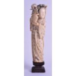 A 19TH CENTURY CHINESE POLYCHROMED CARVED IVORY FIGURE OF A FEMALE modelled holding an urn of