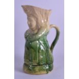 A 19TH CENTURY CONTINENTAL WHIELDON TYPE POTTERY JUG in the form of a standing female. 24.5 cm