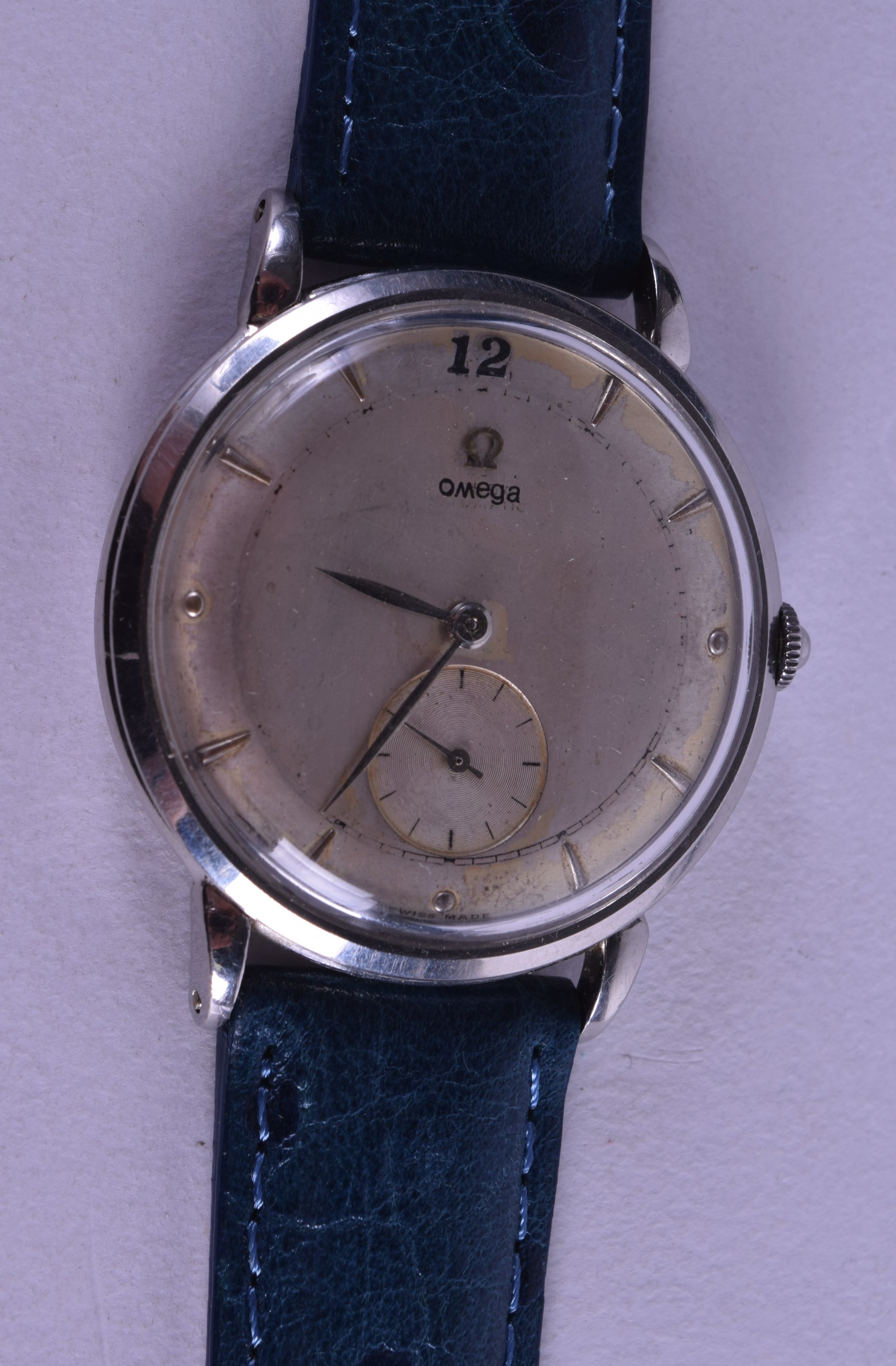 A VINTAGE OMEGA WRISTWATCH with gilt toned dial. 3 cm diameter.