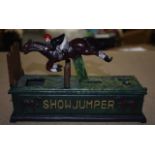 A CAST IRON SHOWJUMPER MONEY BOX.