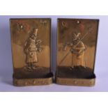 A PAIR OF 19TH CENTURY DUTCH BRASS CANDLE HOLDERS depicting figures roaming within landscapes. 34 cm