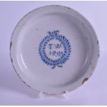 A LATE 17TH CENTURY ENGLISH BLUE AND WHITE DELFT DISH painted with initials TW 1699. 23 cm