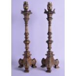 A PAIR OF 18TH/19TH CENTURY CONTINENTAL BRASS CANDLESTICKS with lamp fittings. Stick 39 cm high.