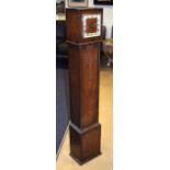 A 1940S OAK GRANDMOTHER CLOCK with square dial. 125 cm high.