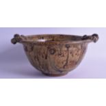 A STYLISH TWIN HANDLED STUDIO POTTERY TWIN HANDLED BOWL decorated with floral roundels. 29 cm wide.