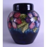 A LARGE MOORCROFT GINGER JAR AND COVER decorated with stylised flowers. 27 cm x 21 cm.