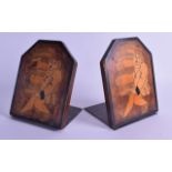 A PAIR OF EARLY 20TH CENTURY EUROPEAN POLKAWORK WOOD BOOK ENDS decorated with figures carrying