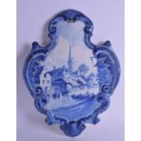 AN EARLY 20TH CENTURY DELFT BLUE AND WHITE POTTERY WALL PLAQUE painted with figures on a boat upon a