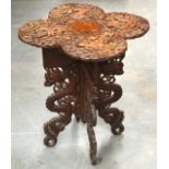 A 19TH CENTURY SOUTH EAST ASIAN CARVED WOOD DRAGON TABLE with folding base.