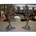 A PAIR OF EARLY 20TH CENTURY FRENCH BRASS CANDLEABRA supported by cherubs. 35 cm high.