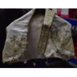 AN 18TH CENTURY EASTERN SILK WAISTCOAT with matching jewelled belt. (2)