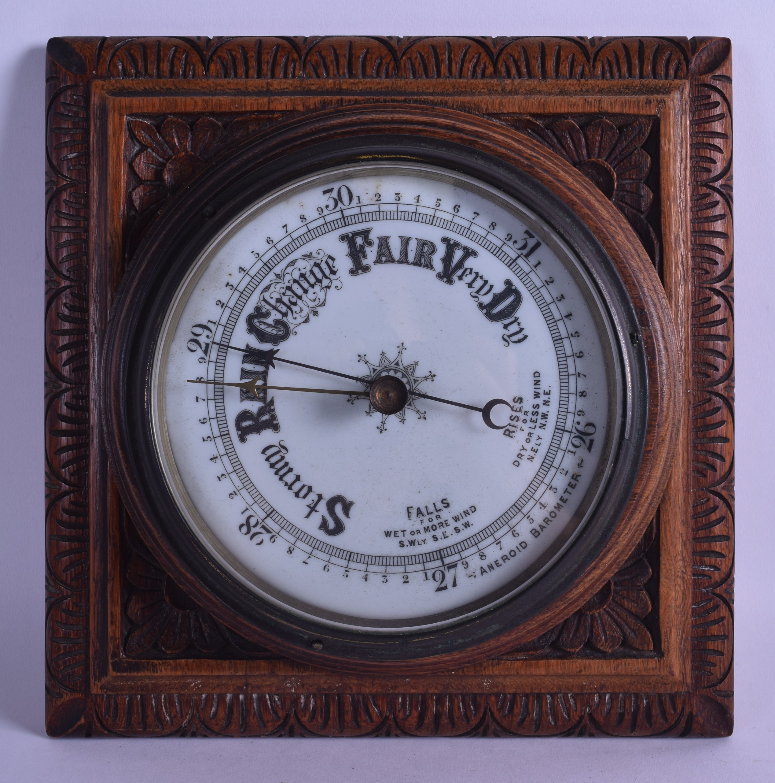 A LATE VICTORIAN/EDWARDIAN OAK CASED ANEROID BAROMETER. 28 cm square.