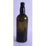 AN EARLY 19TH CENTURY GREEN WINE BOTTLE inset with a seal ST 1828. 29 cm high.