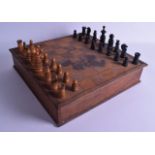 AN ANTIQUE CARVED WOOD CHESS SET with gaming board to top. Largest piece 8.25 cm high.