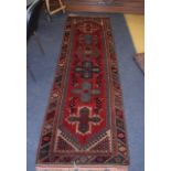 A TURKISH RED GROUND RUNNER decorated with motifs. 280 cm x 74 cm.