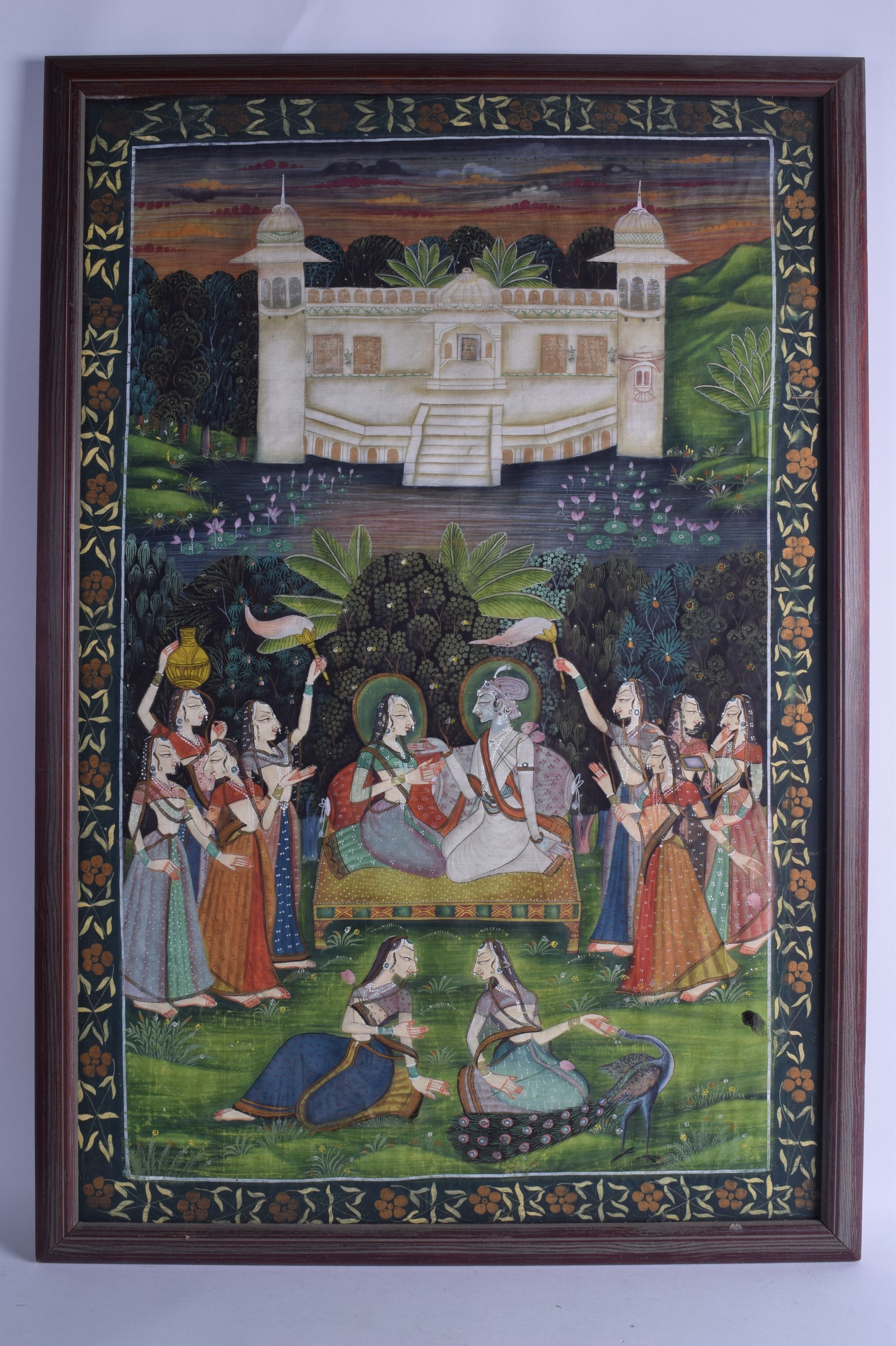 A LARGE 19TH CENTURY INDIAN FRAMED WATERCOLOUR ON SILK depicting buddhistic figures within