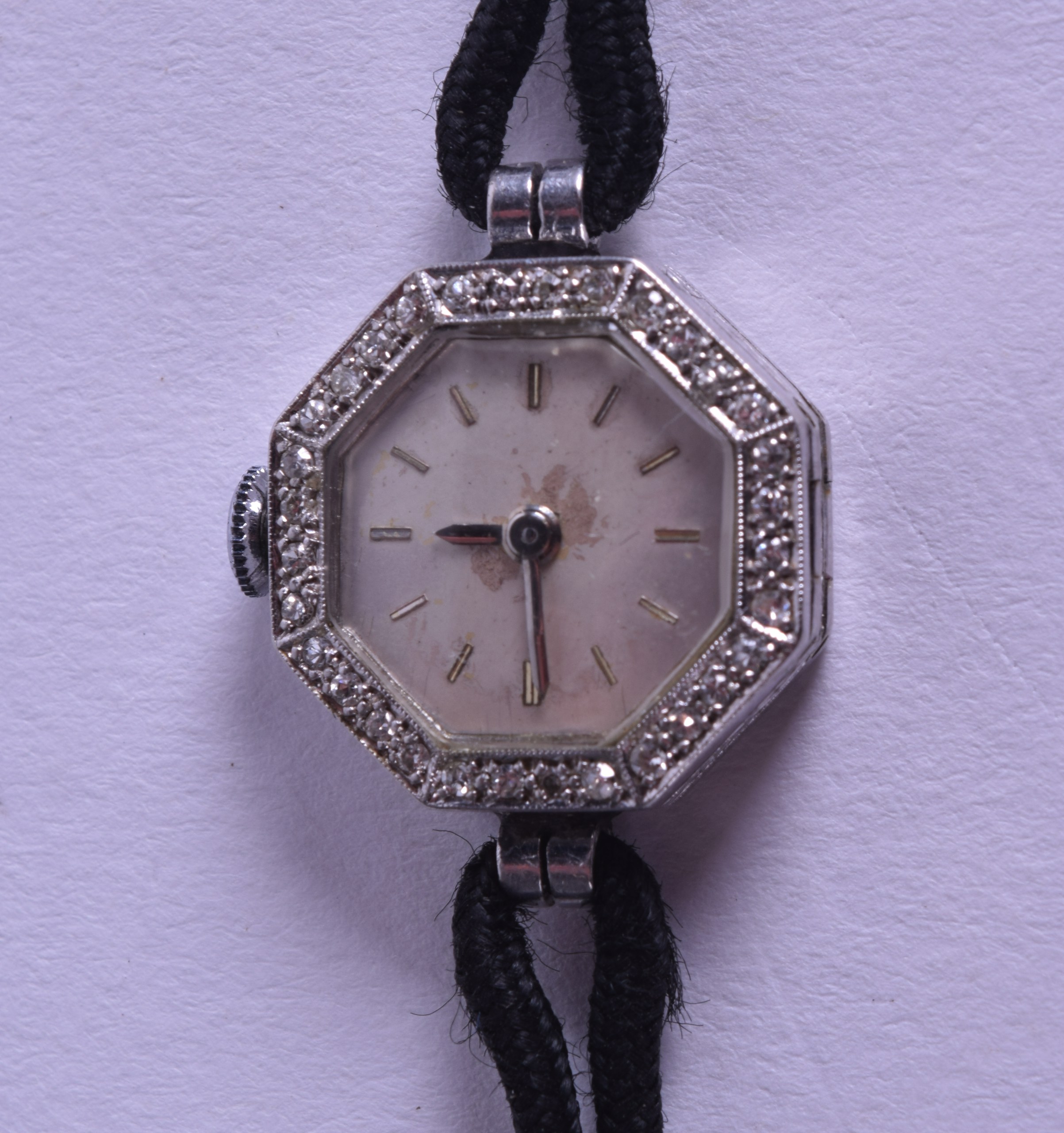 A VINTAGE LADIES WHITE METAL WRISTWATCH with diamond mounts. 1.5 cm wide.