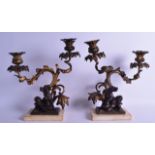 A PAIR OF 19TH CENTURY FRENCH GILT BRONZE TWIN LIGHT CANDELABRA with cast sconces hung with