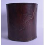 A CHINESE QING DYNASTY CARVED HARDWOOD BRUSH POT Bitong, possibly Huanghuali, decorated with foliage