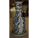 AN EARLY 20TH CENTURY PERSIAN VASE painted with flowers. 25.5 cm high.