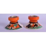 AN UNUSUAL PAIR OF 1920S CLARICE CLIFF FANTASQUE CANDLE HOLDERS painted with landscapes. 8.75 cm