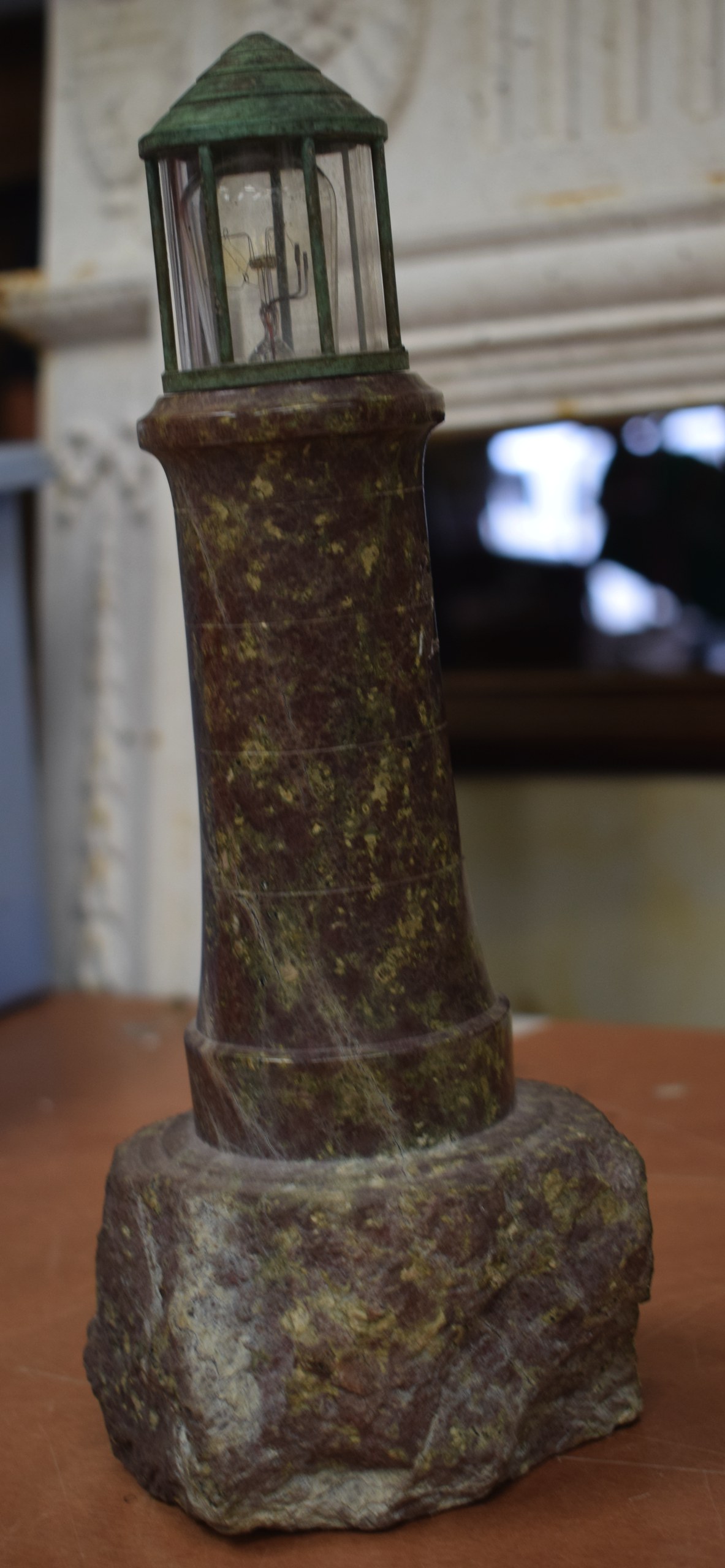 A VINTAGE CARVED SERPENTINE LIGHTHOUSE LAMP. 28 cm high.