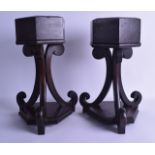 A PAIR OF VICTORIAN CARVED WOODEN CHURCH PLANTERS upon hexagonal bases with scrolling supports. 39