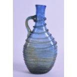 AN EARLY MIDDLE EASTERN RIBBED GLASS FLASK. 15.5 cm high.