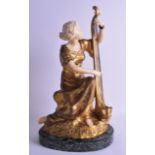 A LARGE ART NOUVEAU GILT BRONZE AND CARVED IVORY FIGURE OF A FEMALE by T H Somms, modelled playing a