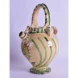 AN EARLY 20TH CENTURY CONTINENTAL MAJOLICA STYLE BASKET JUG painted with floral sprays. 25.5 cm