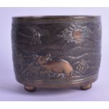 A CHINESE QING DYNASTY CIRCULAR BRONZE CENSER decorated with a beast within a landscape. 499