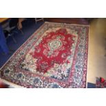 A LARGE CAUCASIAN TABRIZ CARPET decorated with red and beige foliage. 312 cm x 200 cm.