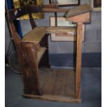 A LARGE ANTIQUE PITCH PINE LECTURN OR DESK with seat.