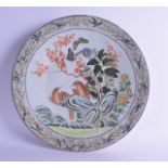 A MID 19TH CENTURY CHINESE CANTON FAMILLE ROSE DISH Daoguang, painted with two birds upon