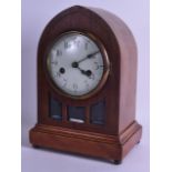 AN EDWARDIAN MANTEL CLOCK with arched case and enamelled dial. 31 cm x 20 cm.